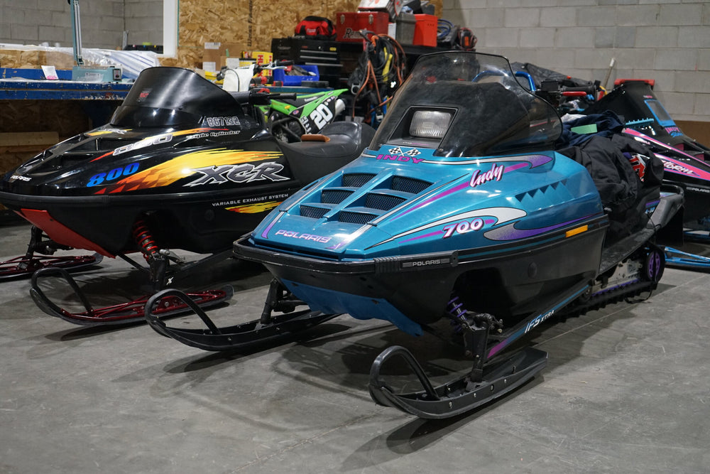 Vintage Polaris snowmobiles with restored graphics