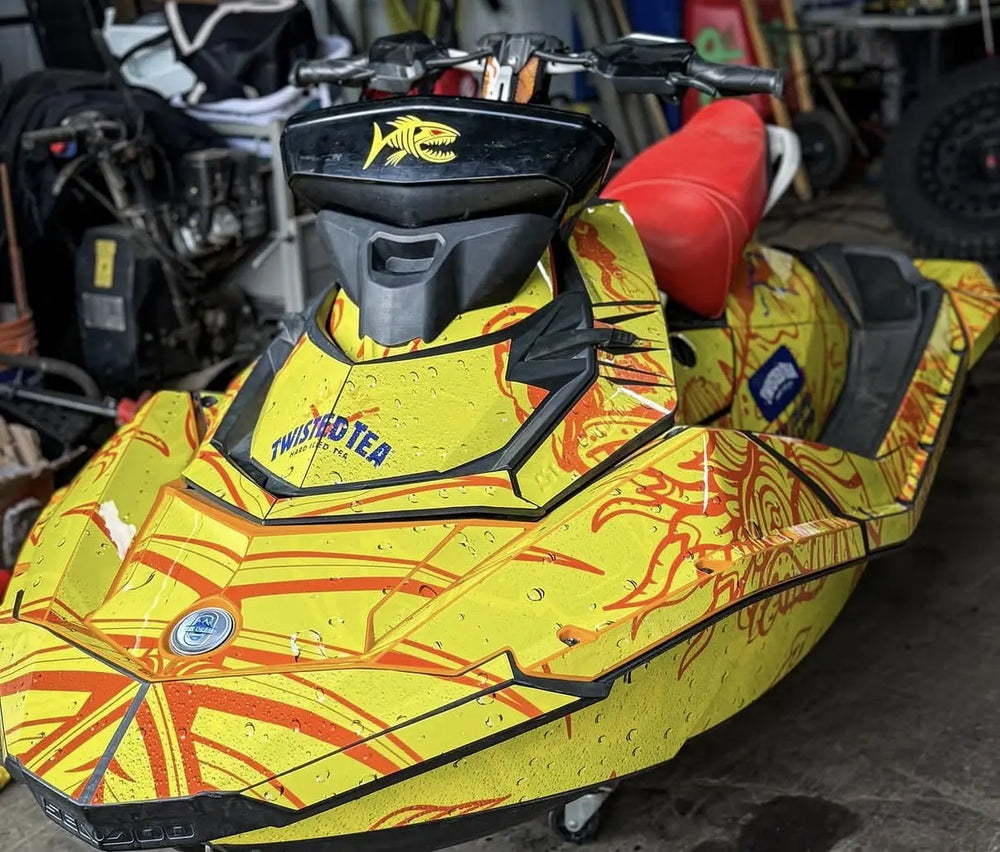 Yellow watercraft with orange illustrated graphics